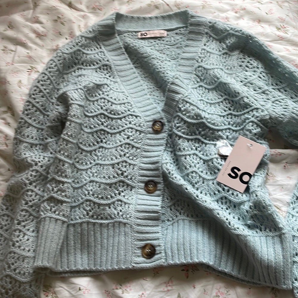 Cute light blue cardigan with brown bottons